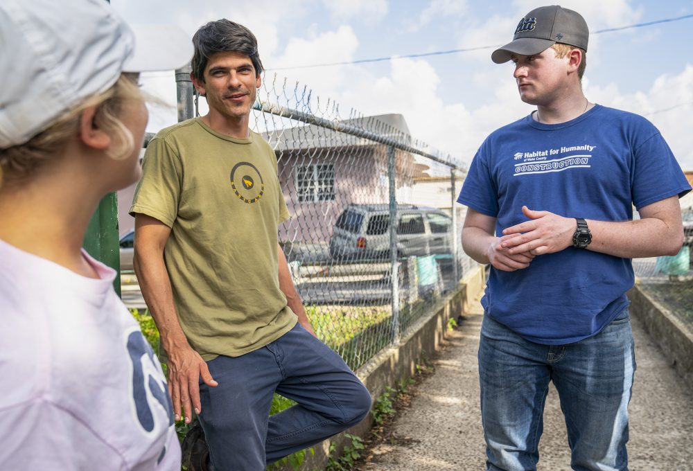 Pitt Business students talk to a Puerto Rican man on the street
