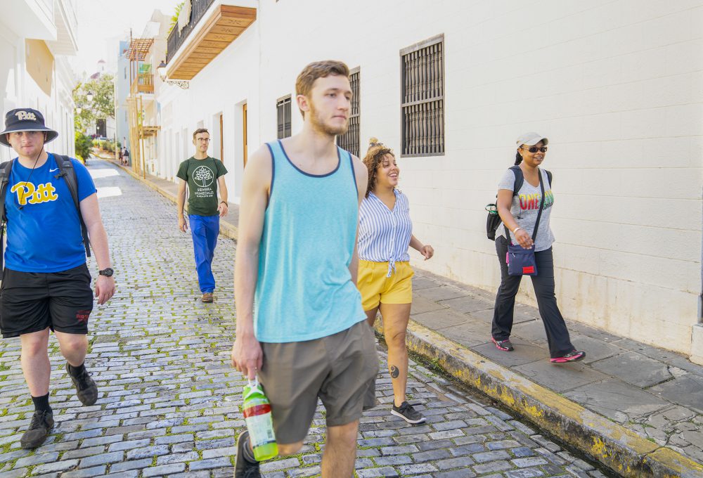 Students walk down cobblestone streets in the old Puerto Rico district